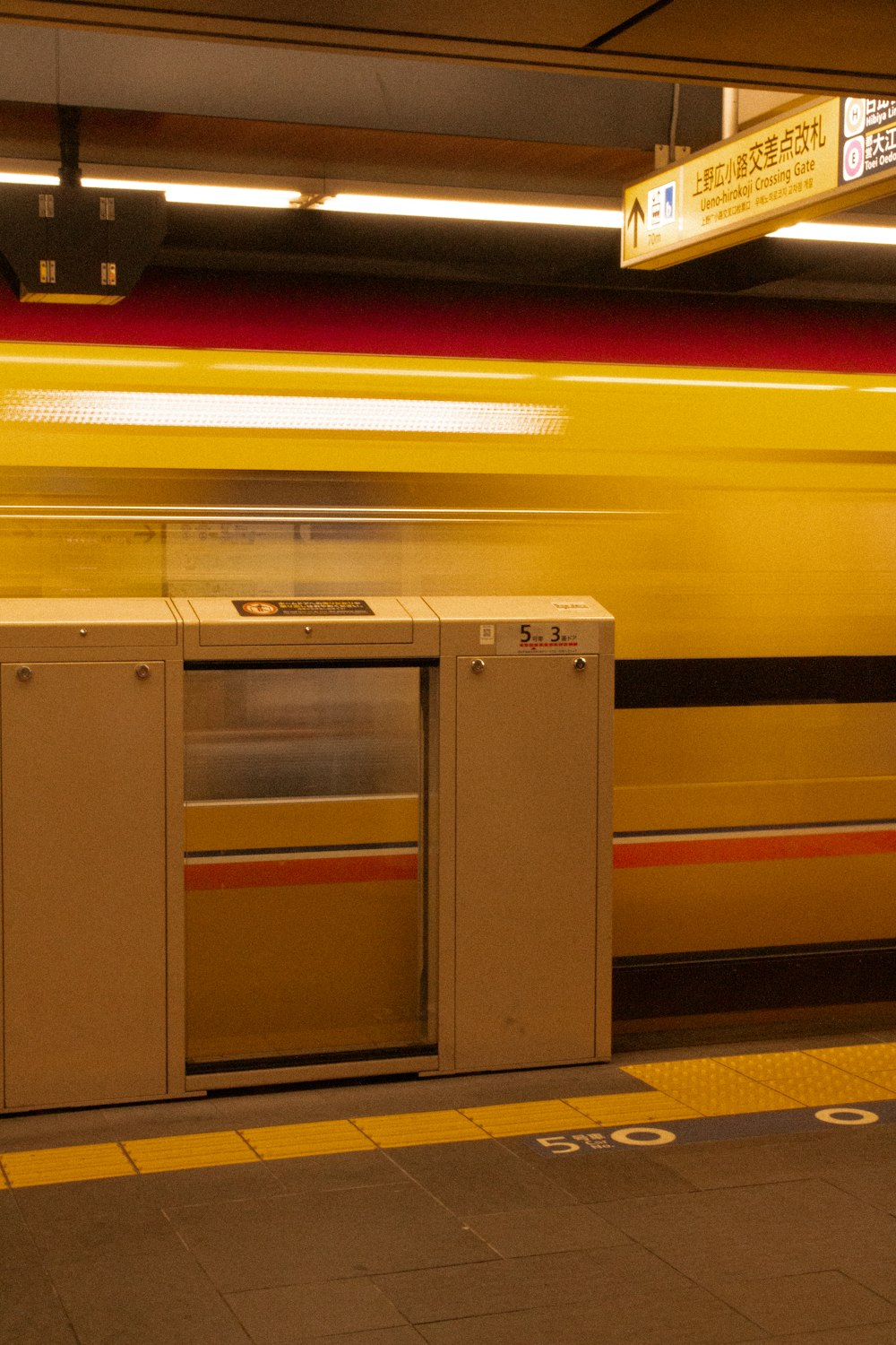 a train passing by a box on a platform