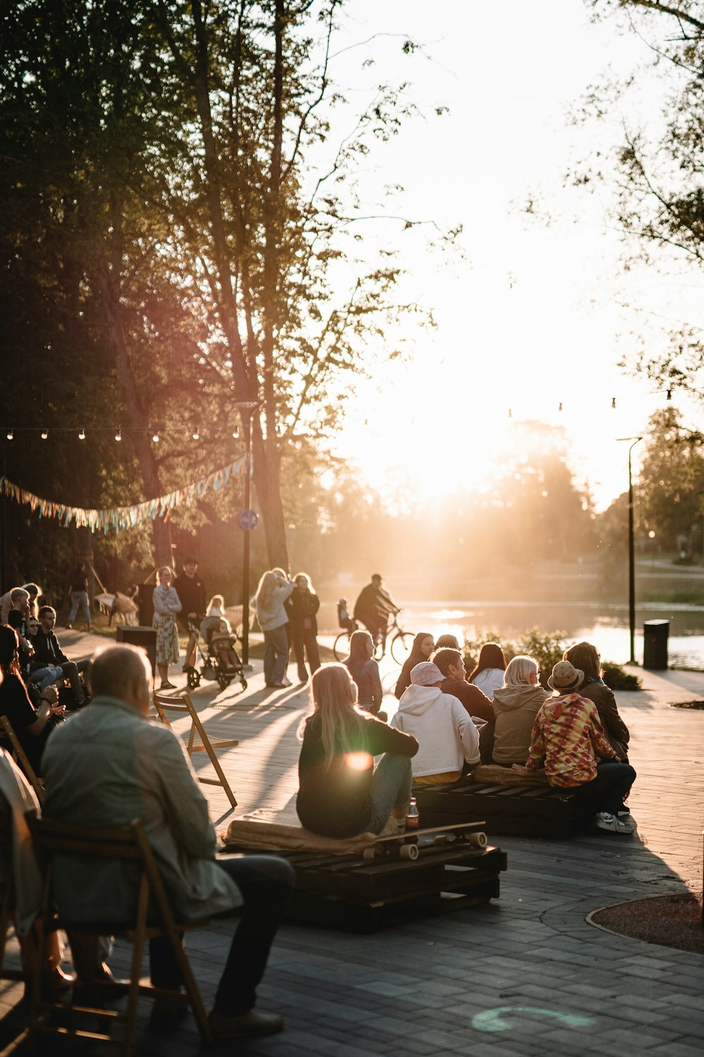 a group of people sitting on top of a wooden deck