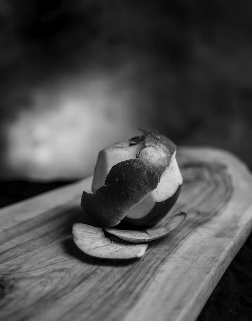 a piece of fruit is sitting on a cutting board