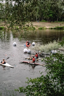 Guests kayaking gently along the peaceful river surrounded by lush greenery.