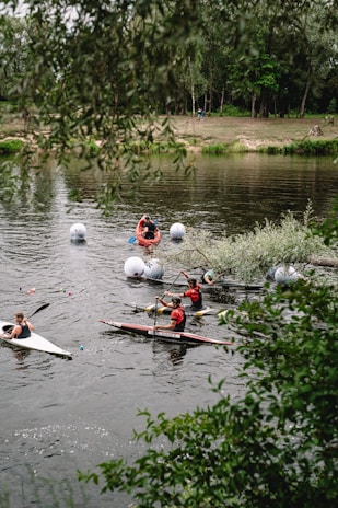 Guests kayaking gently along the peaceful river surrounded by lush greenery.