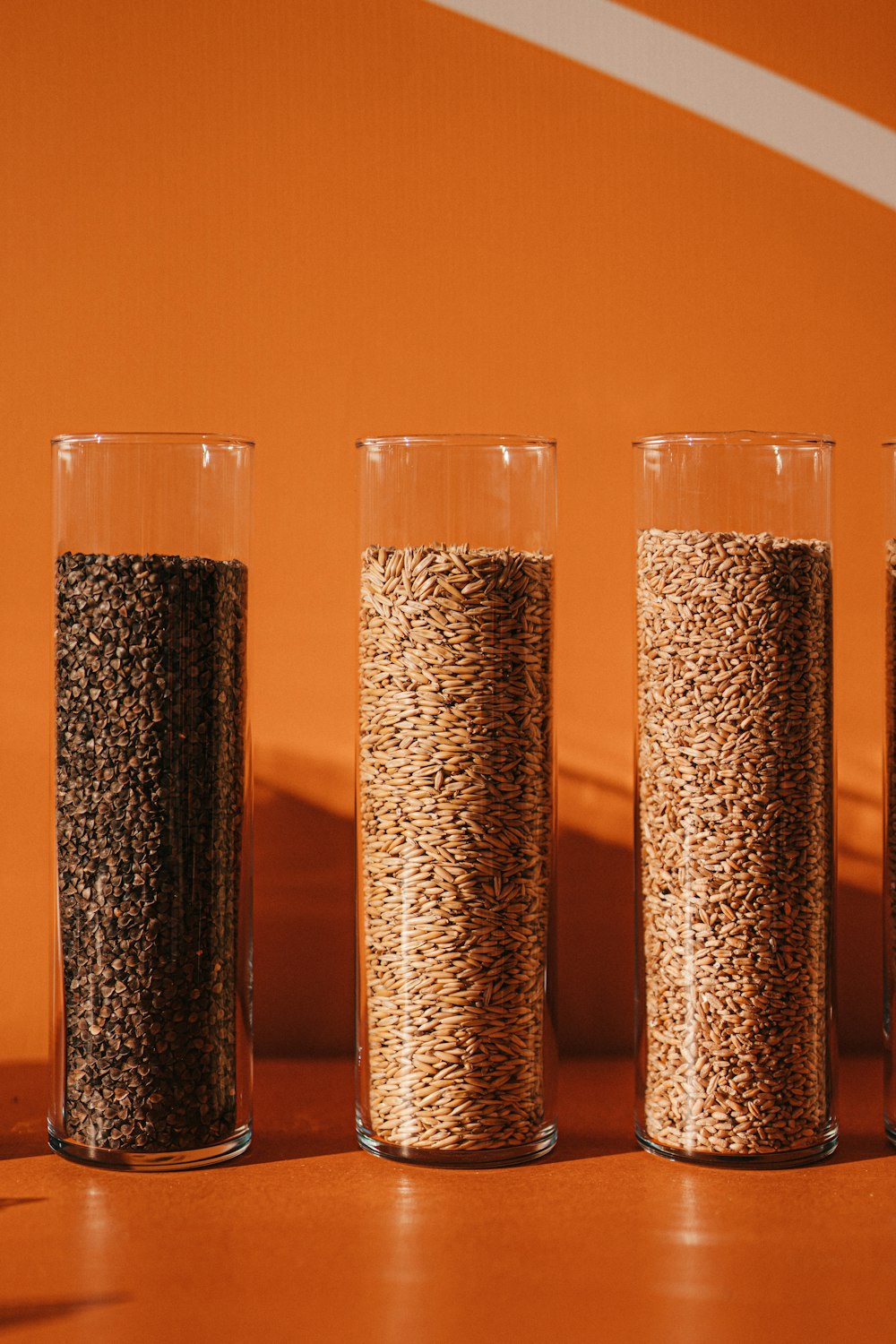 a row of three glasses filled with grains