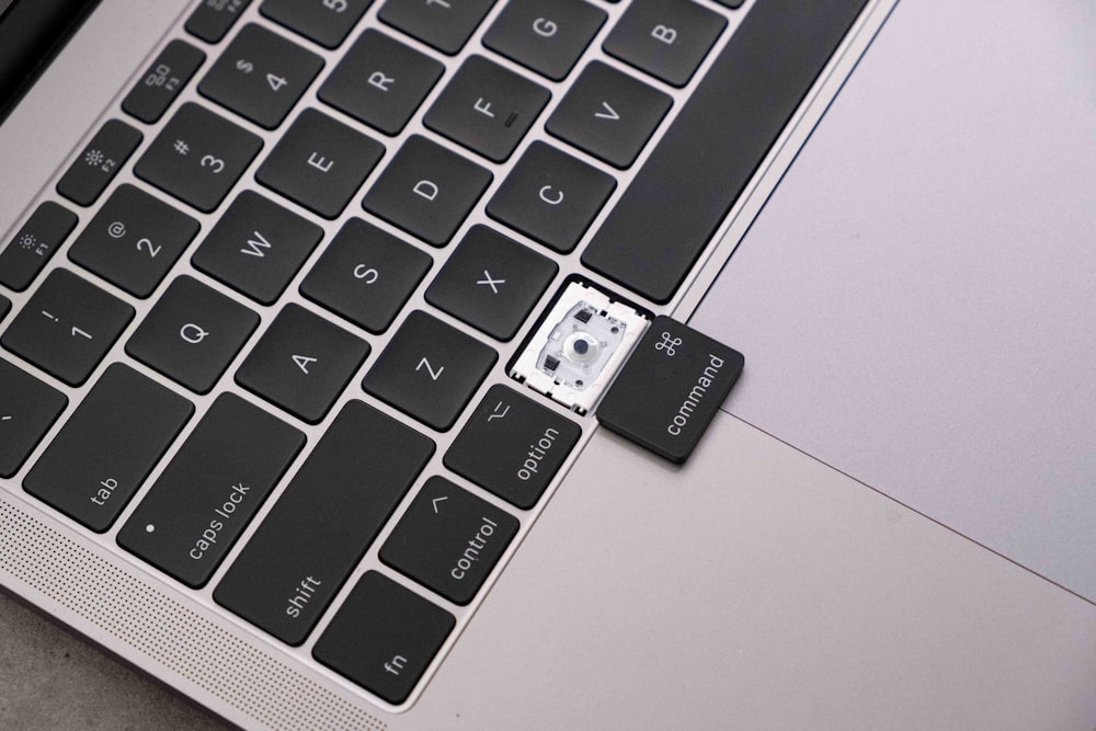 a close up of a laptop keyboard with a sticker on it