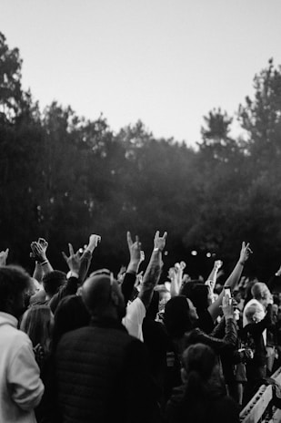 An inspiring photo of a group hug among supporters raising awareness in a park.