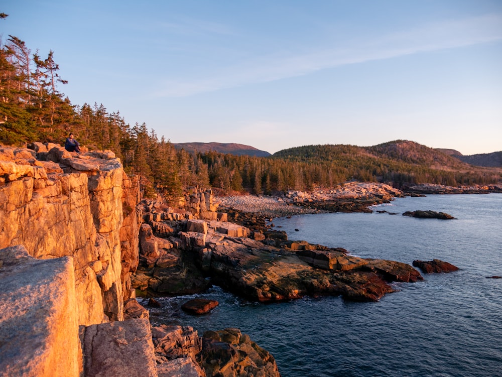 a rocky cliff overlooks a body of water