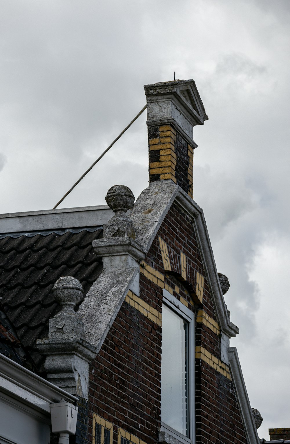 a brick building with a weather vane on top of it