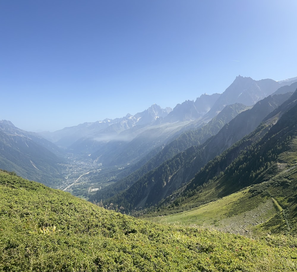 a view of a valley with mountains in the background