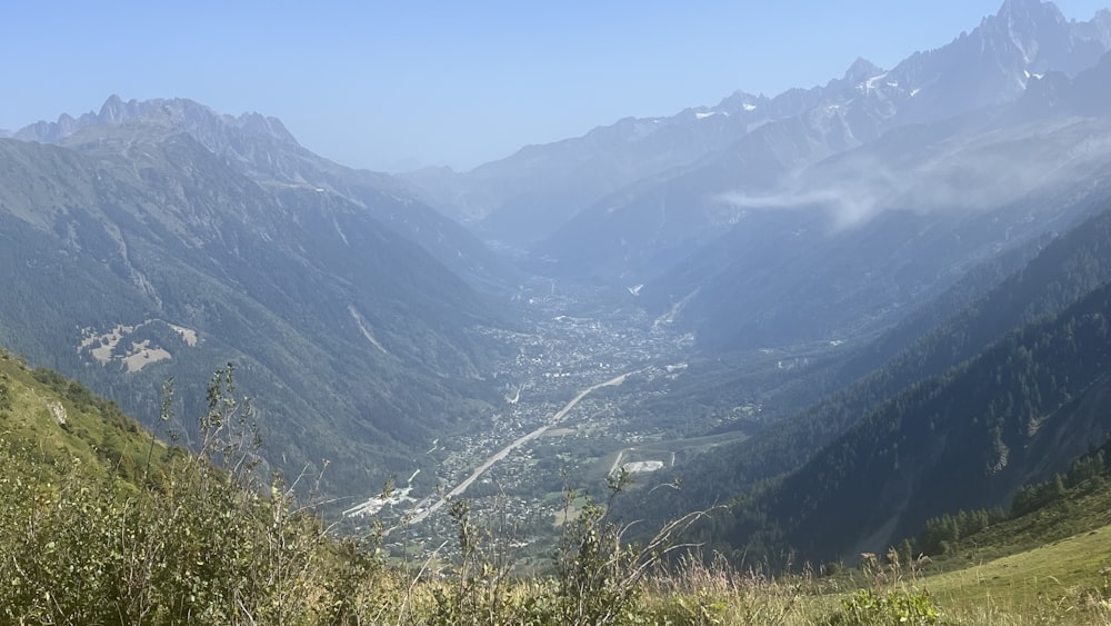 a view of a valley with mountains in the background