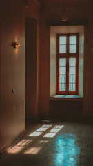 A cozy and modern therapy room with soft blue tones and natural light filtering through a window.