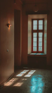 A serene therapy room with soft blue walls and natural light filtering through a window.