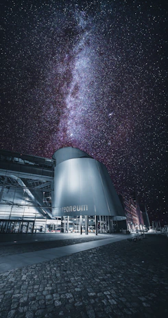 A sleek 3D architectural model of a futuristic space observatory under a starry sky.