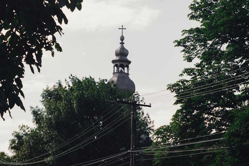 a tall steeple with a cross on top of it