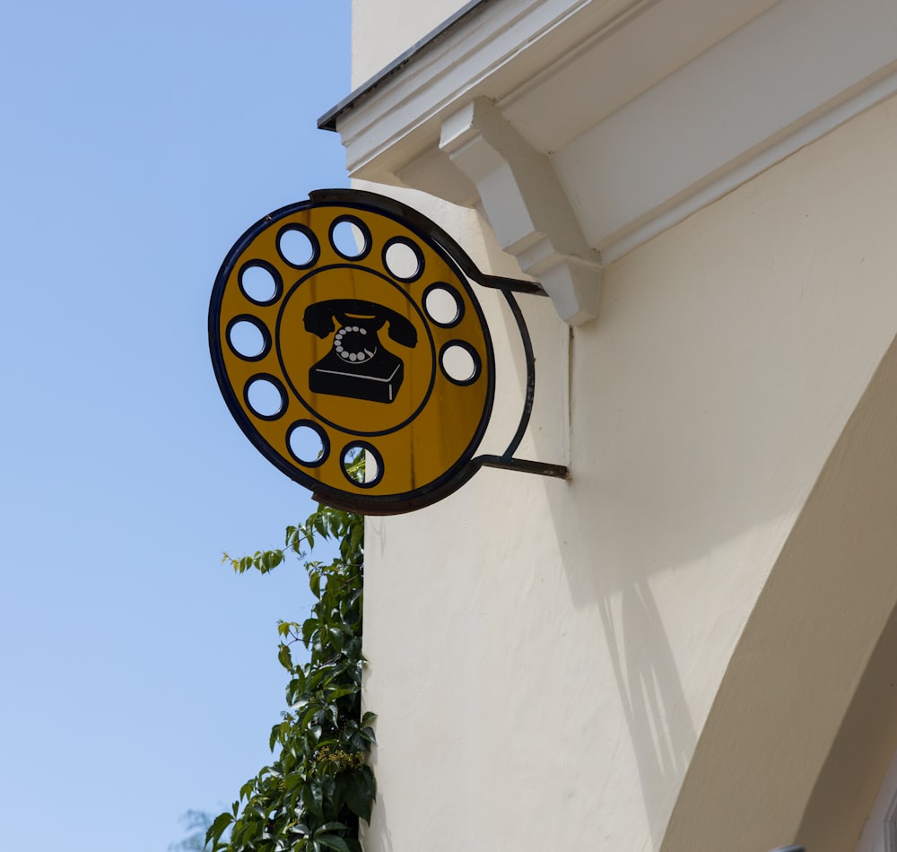 a yellow and black sign on the side of a building