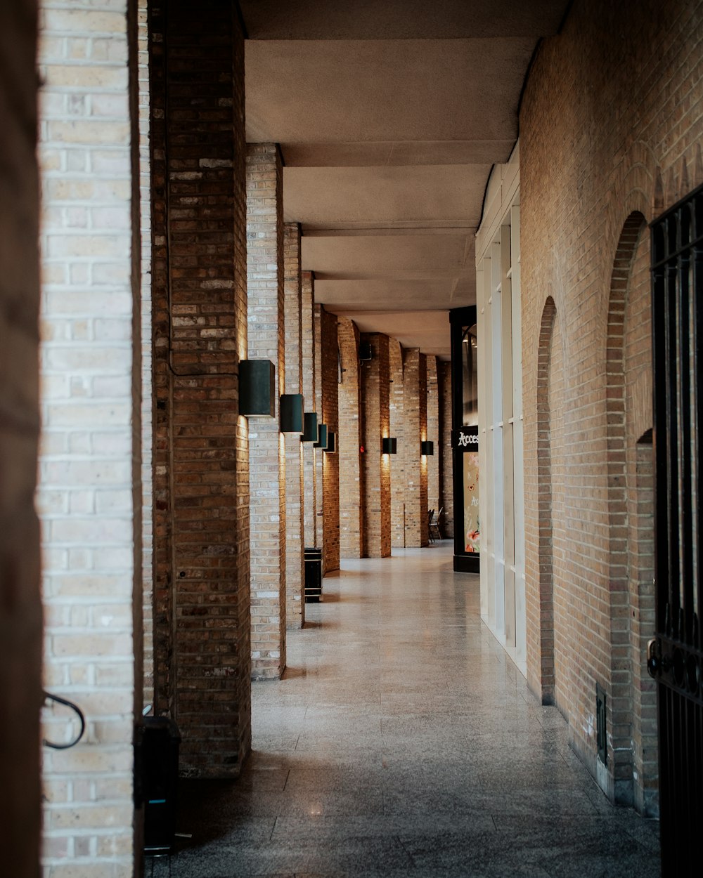 a long hallway between two brick buildings