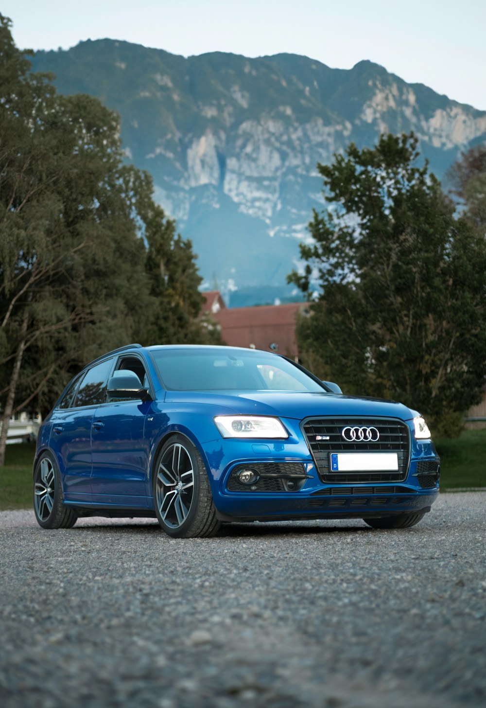 a blue car parked on the side of a road