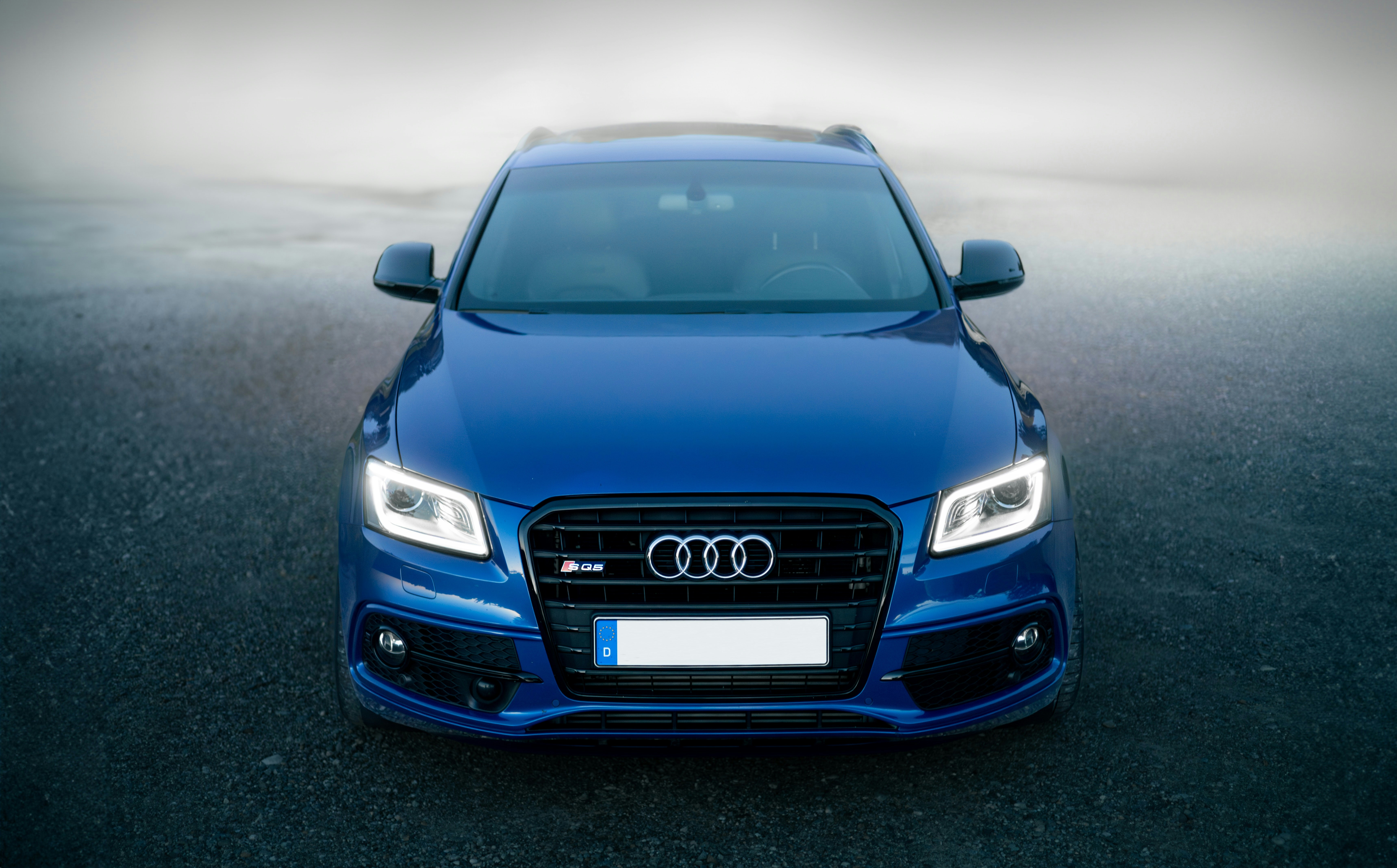 a blue car parked in a parking lot