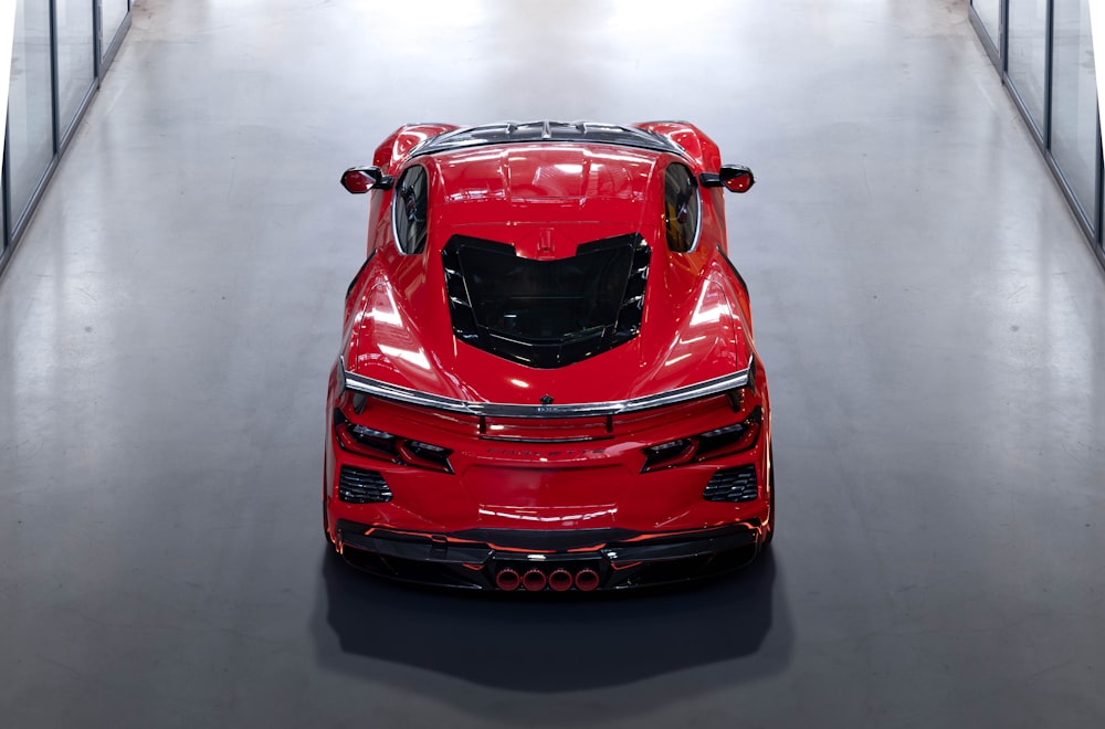 a red sports car parked in a garage