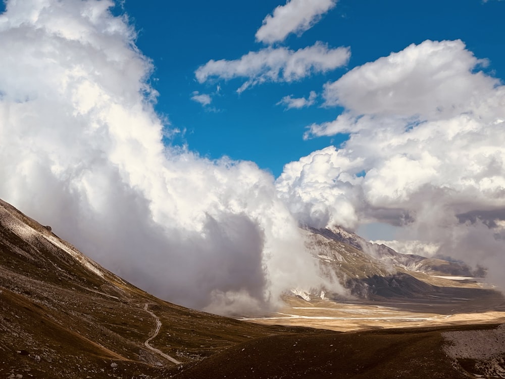 a view of a mountain range with clouds in the sky