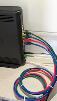 a bunch of Ethernet Cat6 coloured cables that are connected to a internet router