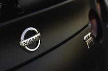 a close up of a nissan emblem on a car