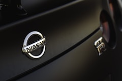 a close up of a nissan emblem on a car