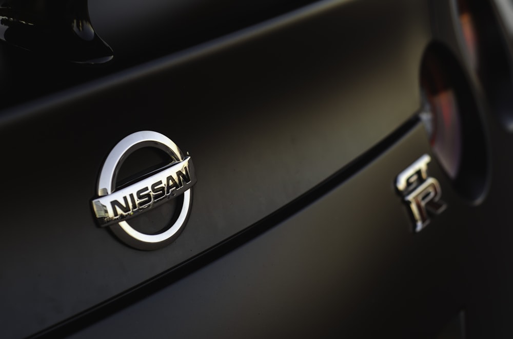 a close up of a nissan emblem on a car