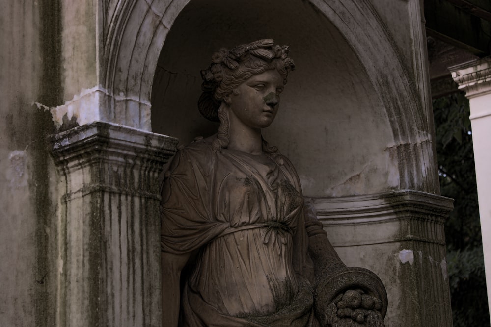 a statue of a woman holding a snake