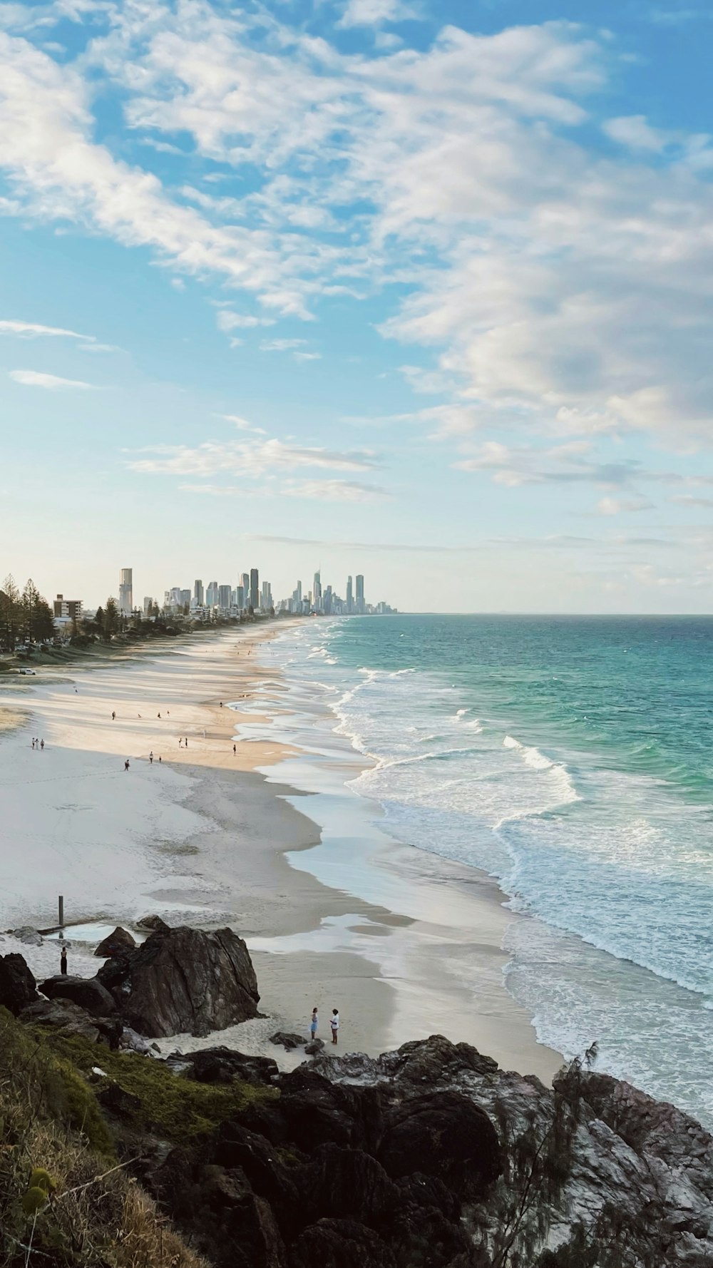 a view of a beach with a city in the background