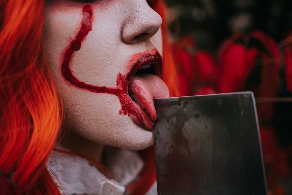 a close up of a person with red hair and makeup