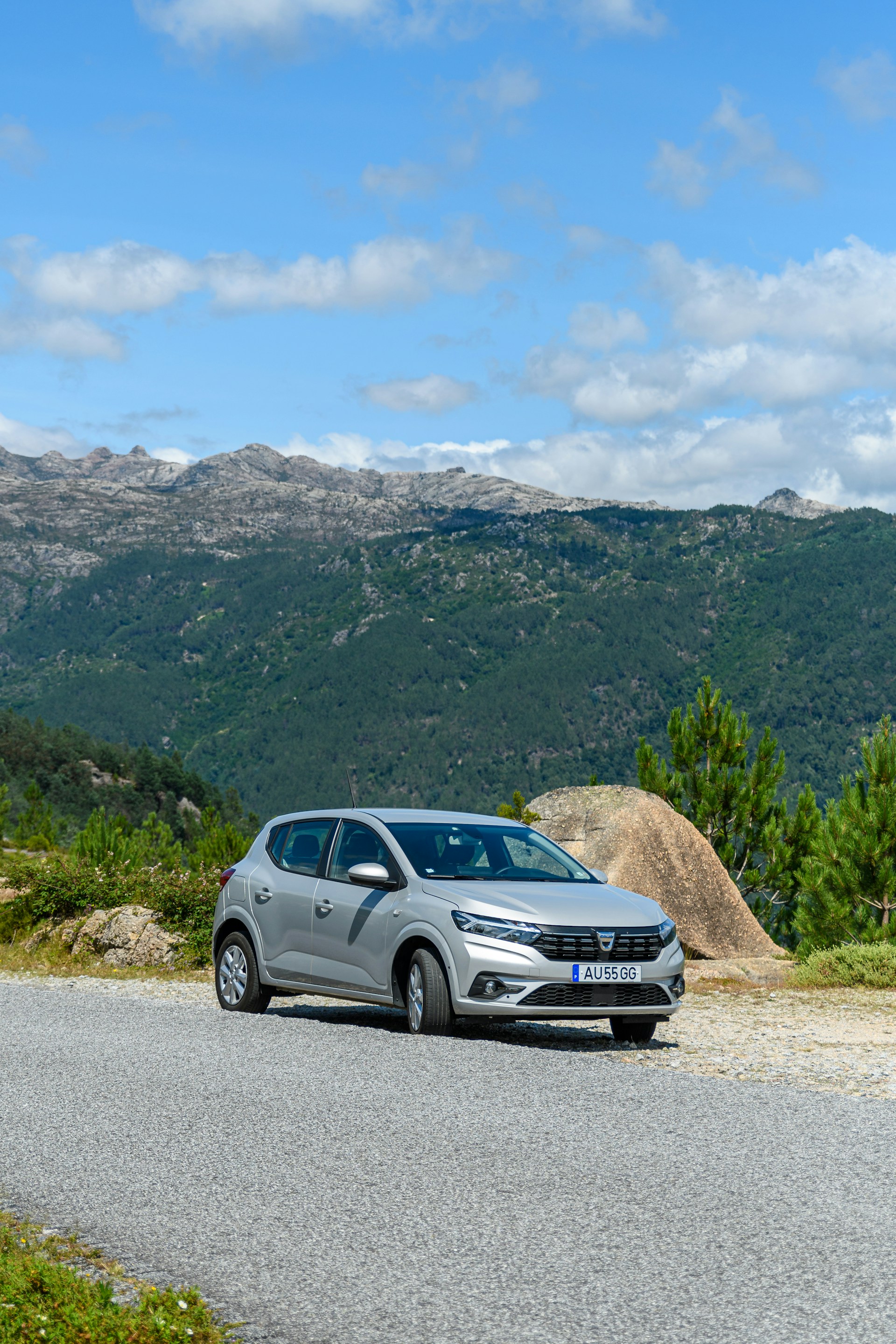 a silver car parked on the side of a road