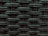 A close-up view of a woven pattern with a textured, grid-like structure. The material appears to be a dark, possibly synthetic fiber that crisscrosses to form a rigid surface. Each strand has a slightly glossy finish, adding depth and dimension to the pattern.