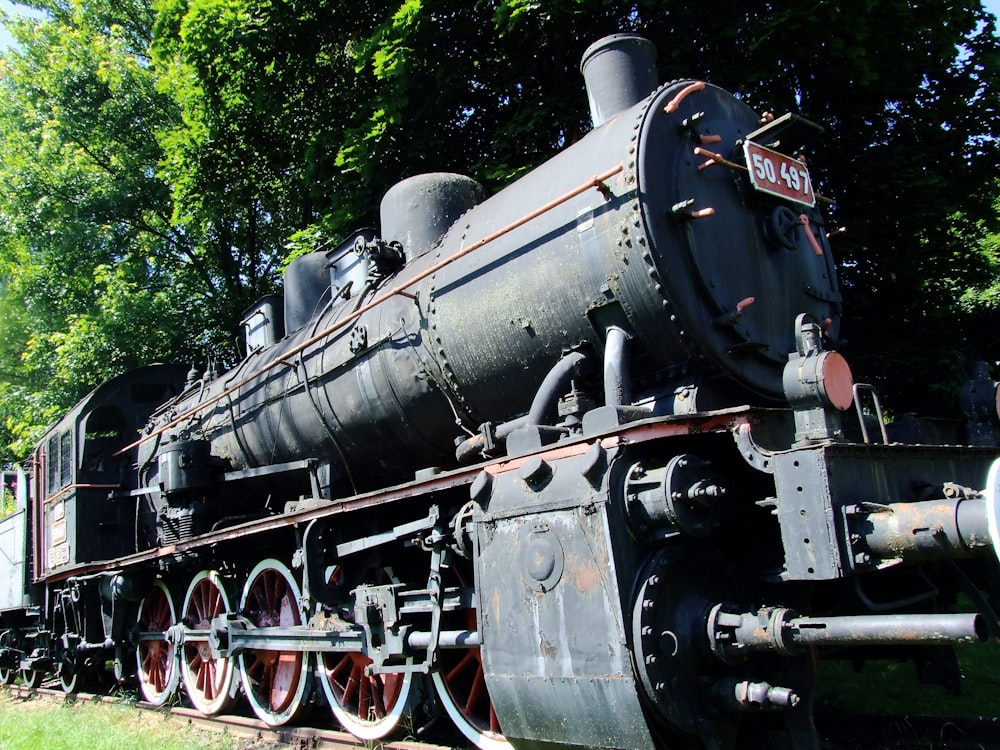 an old steam engine sitting on the tracks