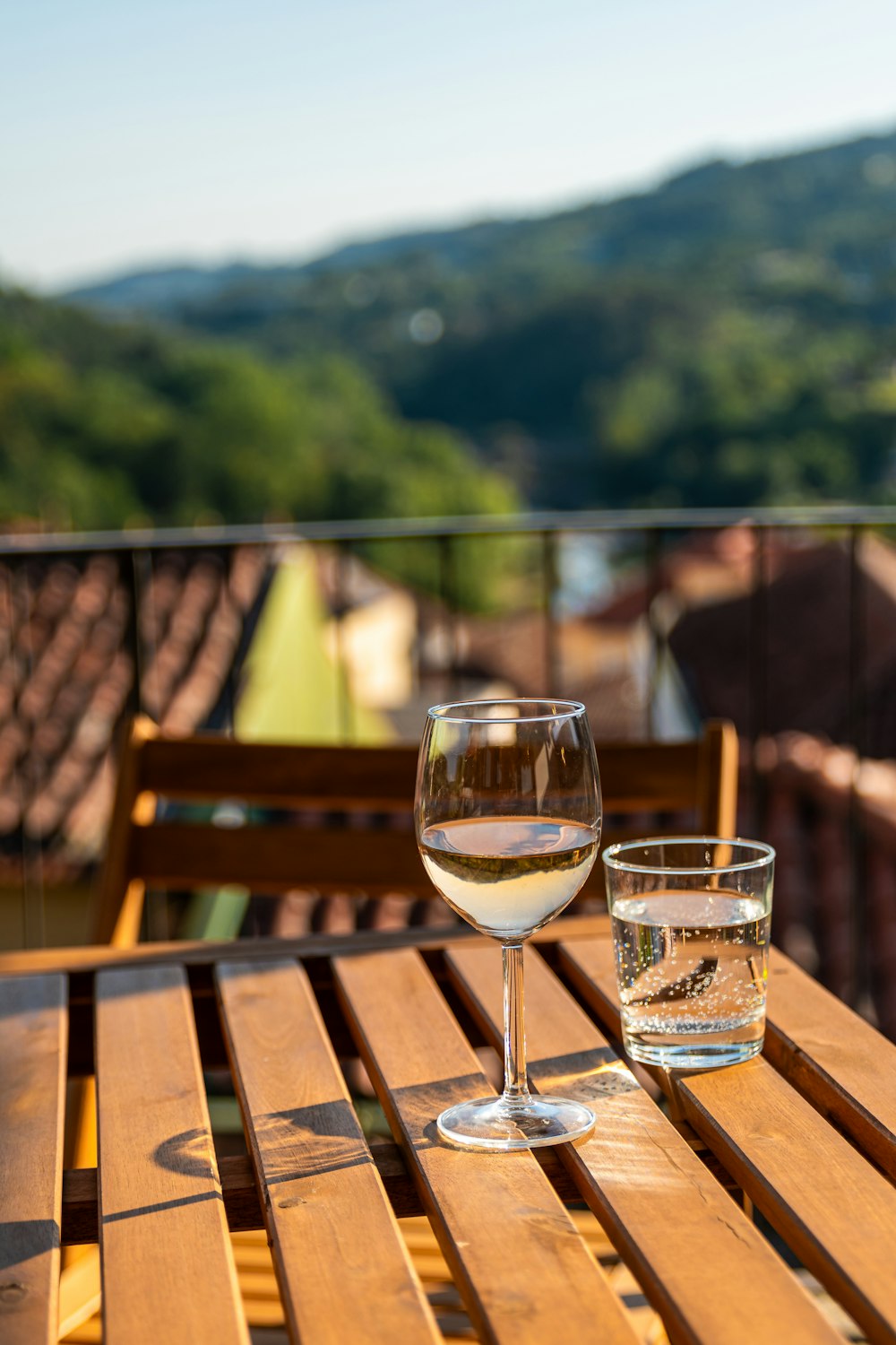 a glass of wine sitting on top of a wooden table