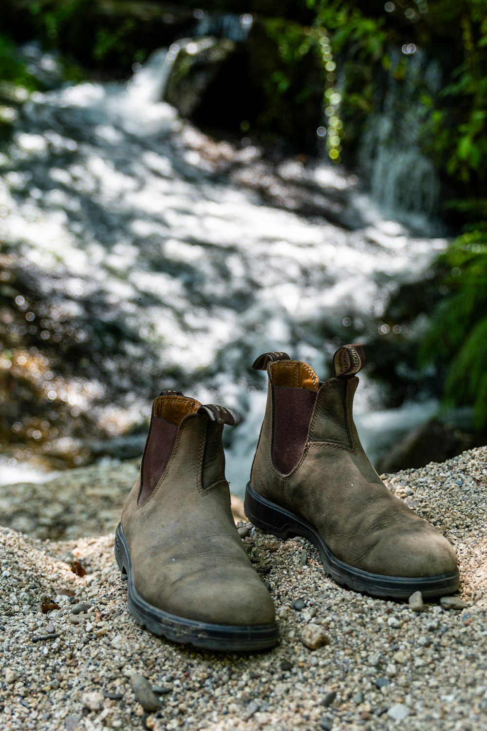 a pair of shoes sitting on top of a rock
