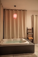A cozy bathroom setup featuring a soft area rug and matching bath accessories.