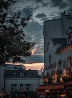 A vibrant street scene in Budapest at sunset, with lively cafes and historic buildings glowing warmly.