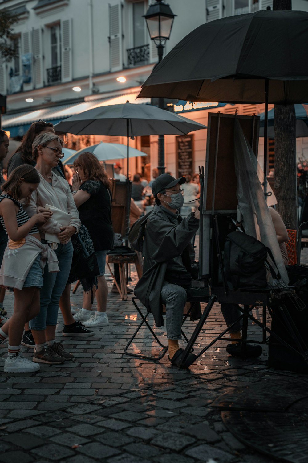 a group of people standing around a street