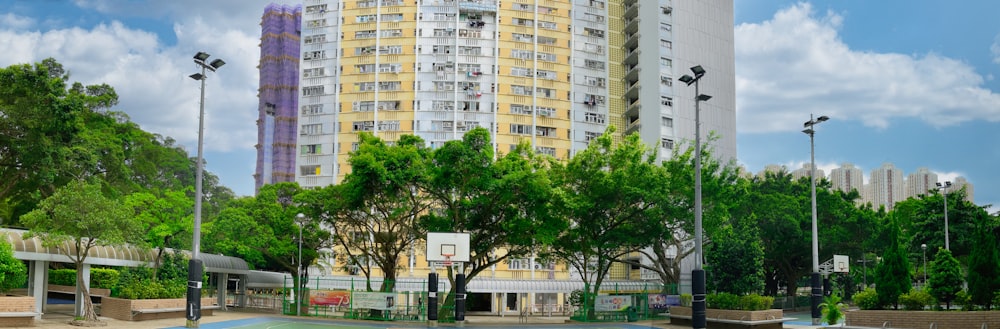a basketball court in front of a tall building