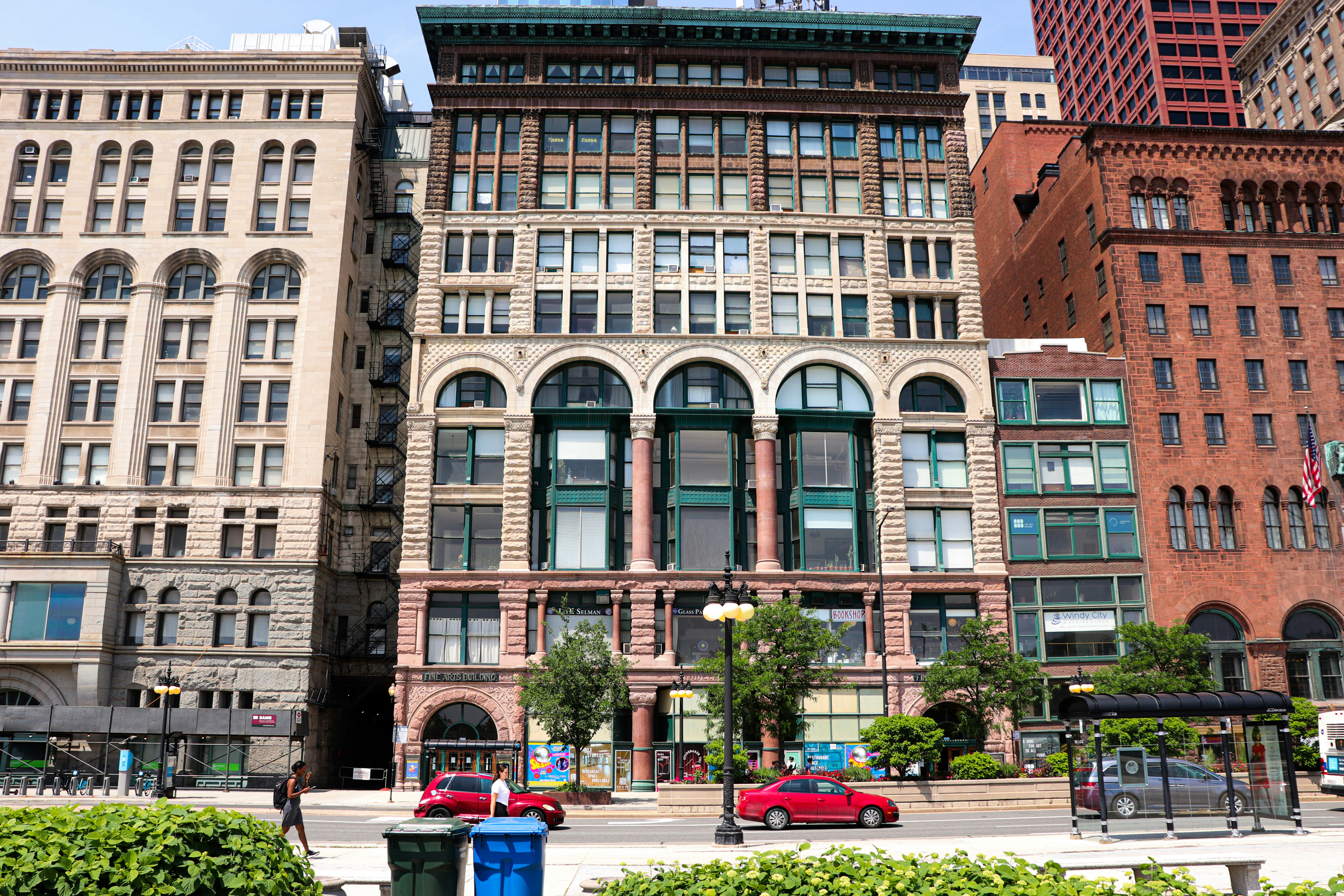 a group of buildings with cars parked in front of them