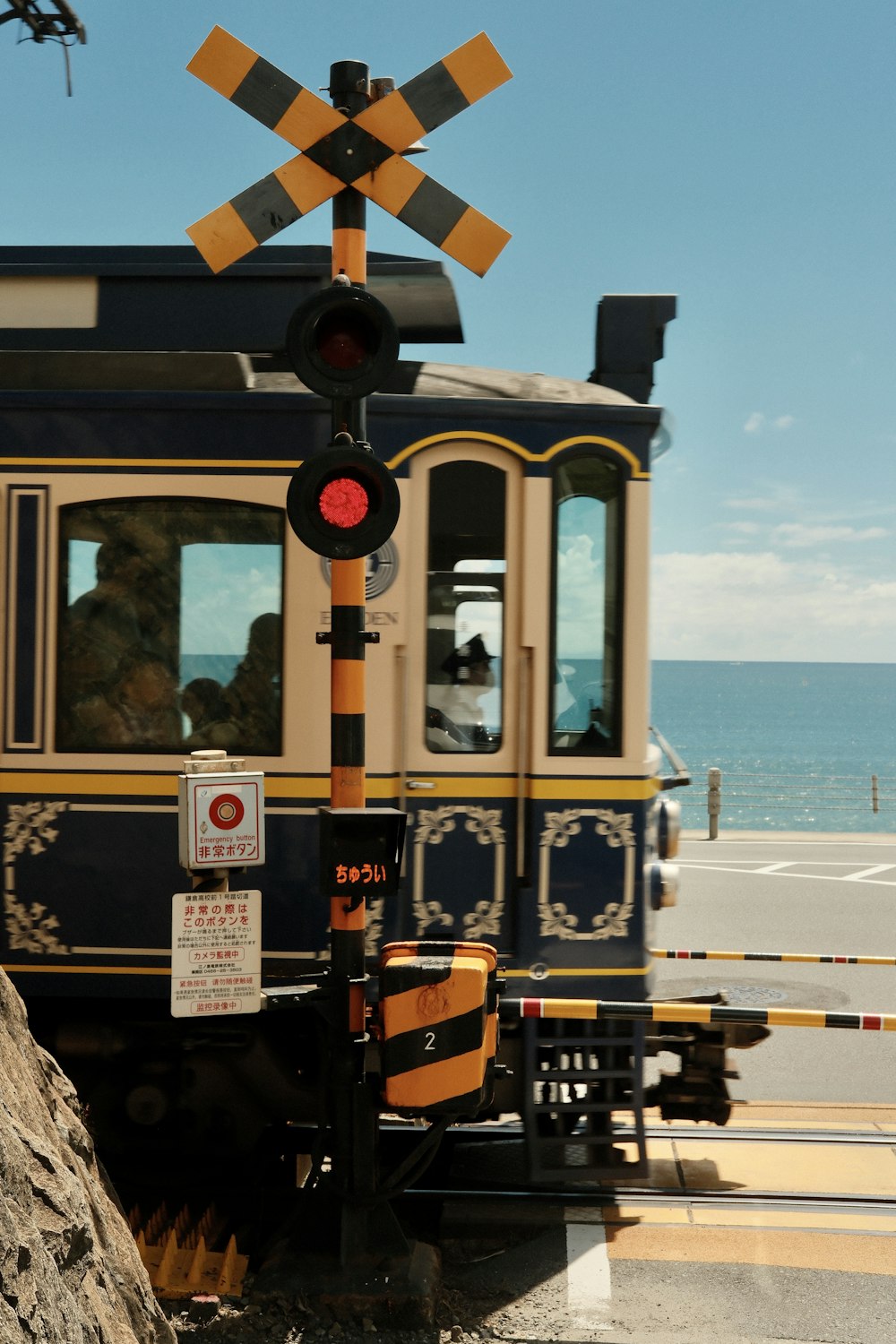 a train traveling down tracks next to the ocean