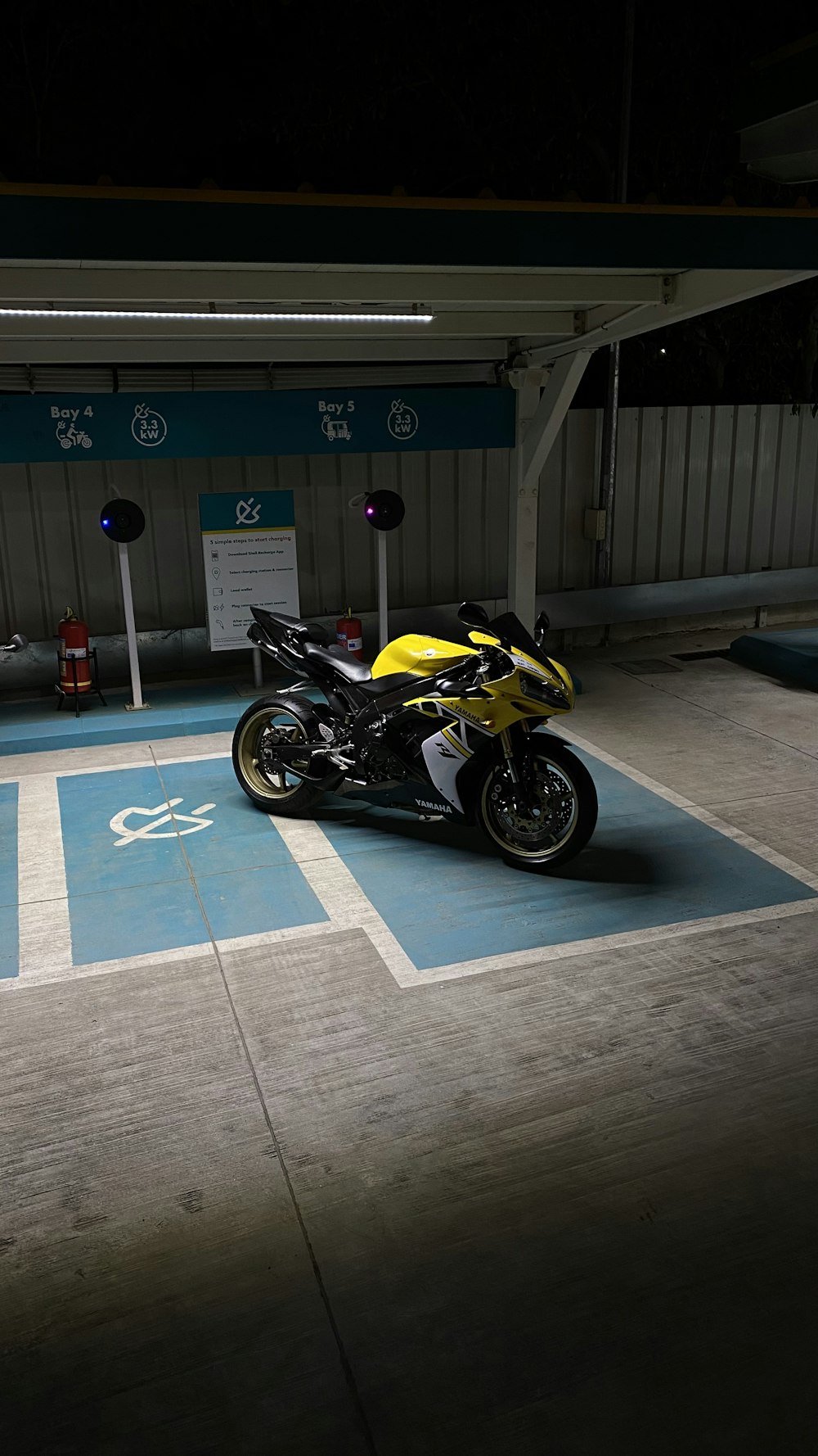 a yellow and black motorcycle parked in a parking lot