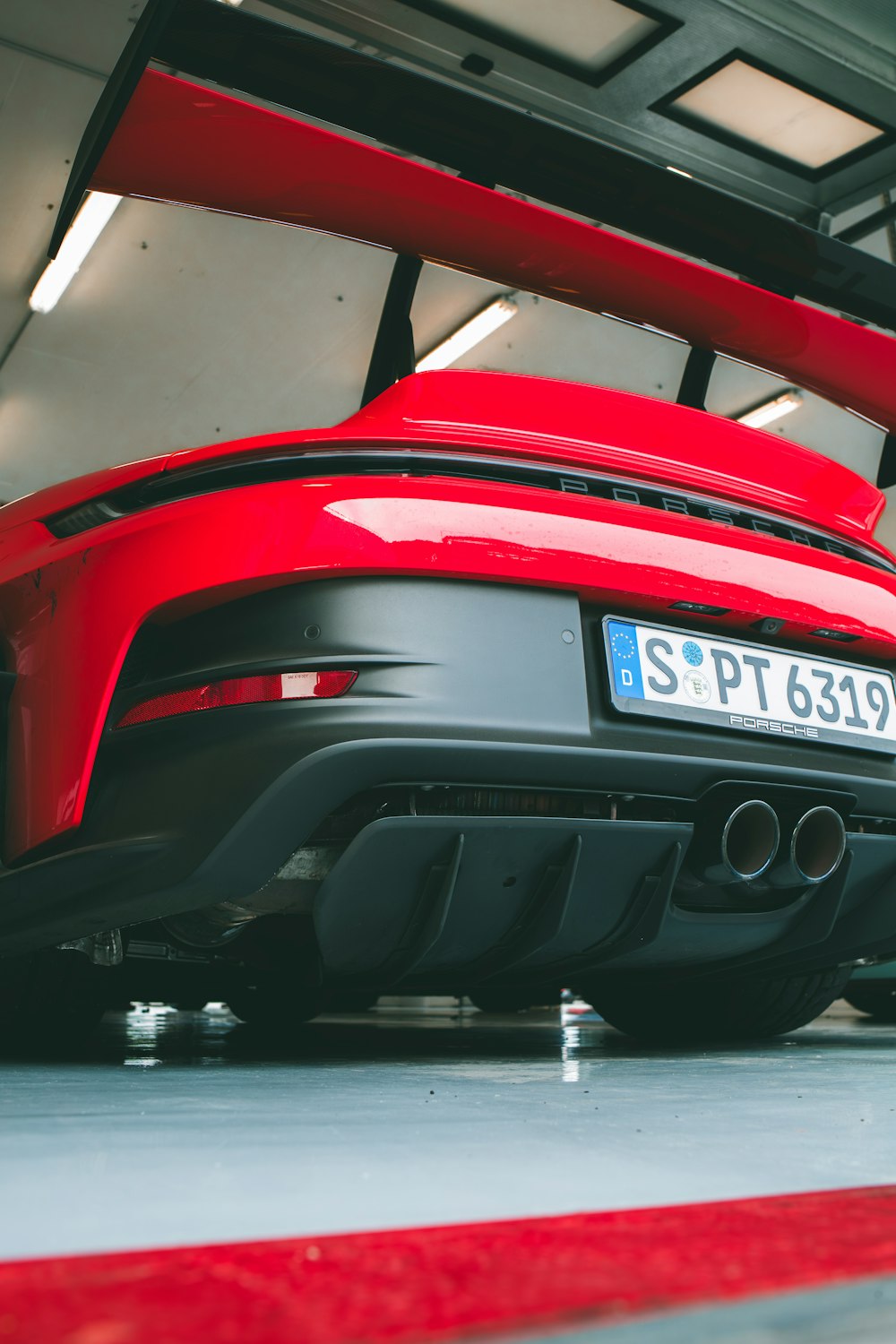 a red sports car parked in a garage