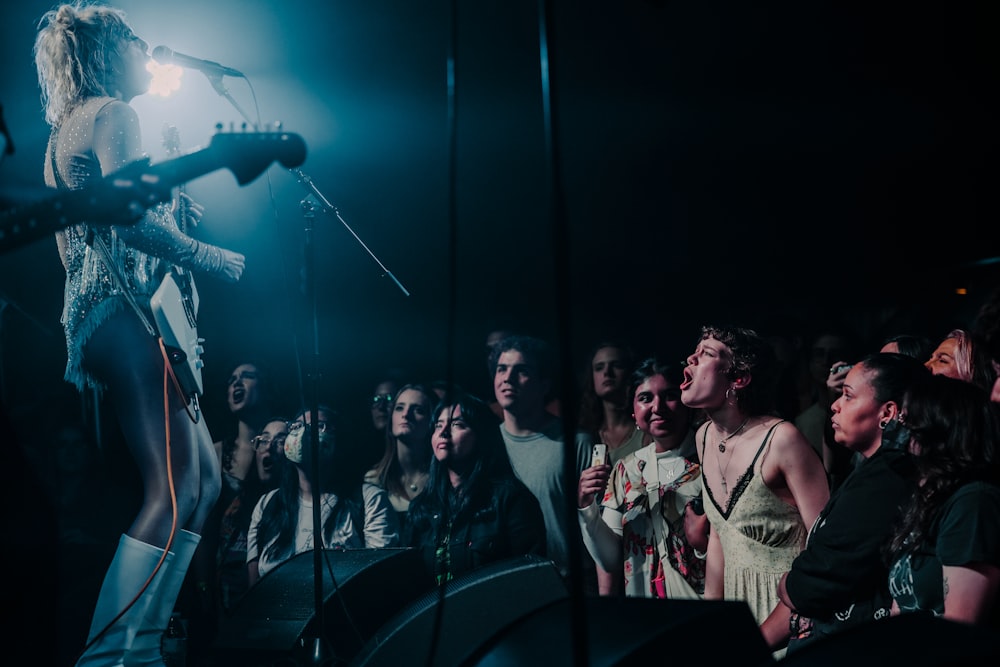 a group of people that are standing in front of a microphone