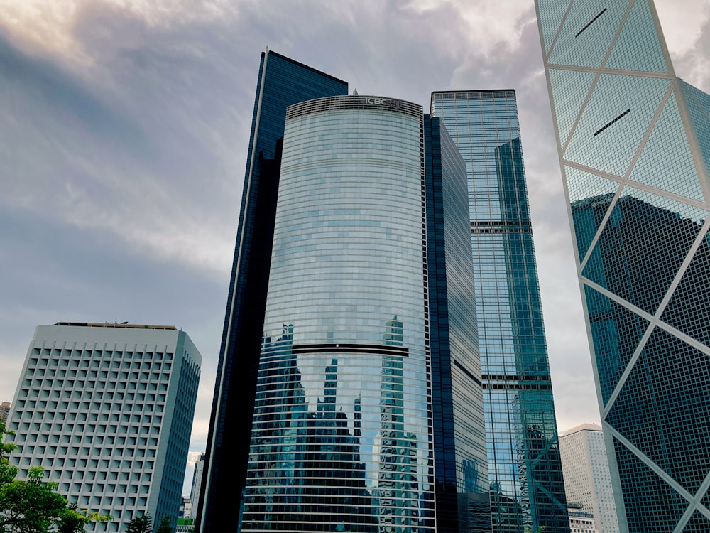 a group of skyscrapers with a cloudy sky in the background