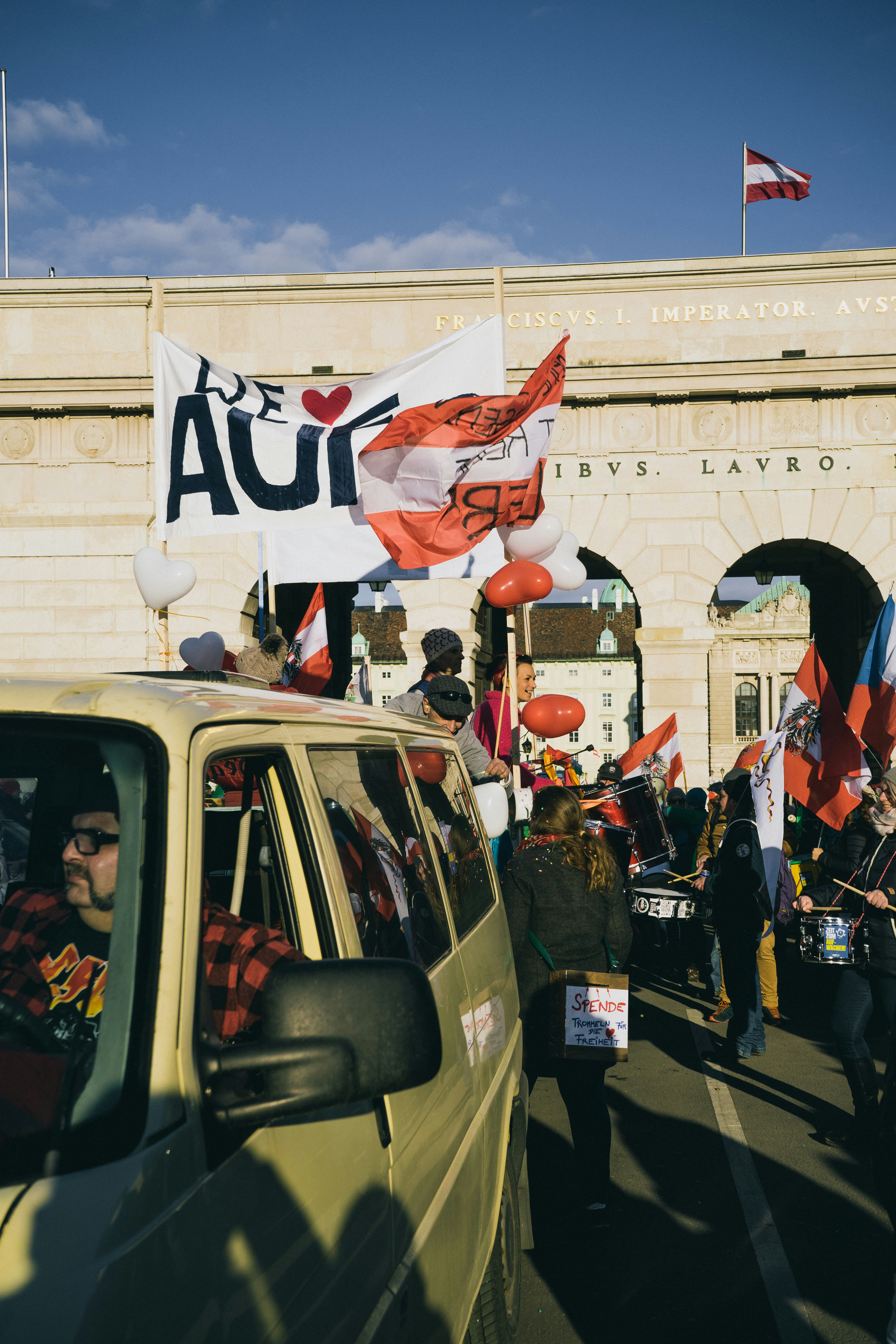 a group of people walking down a street next to a building
