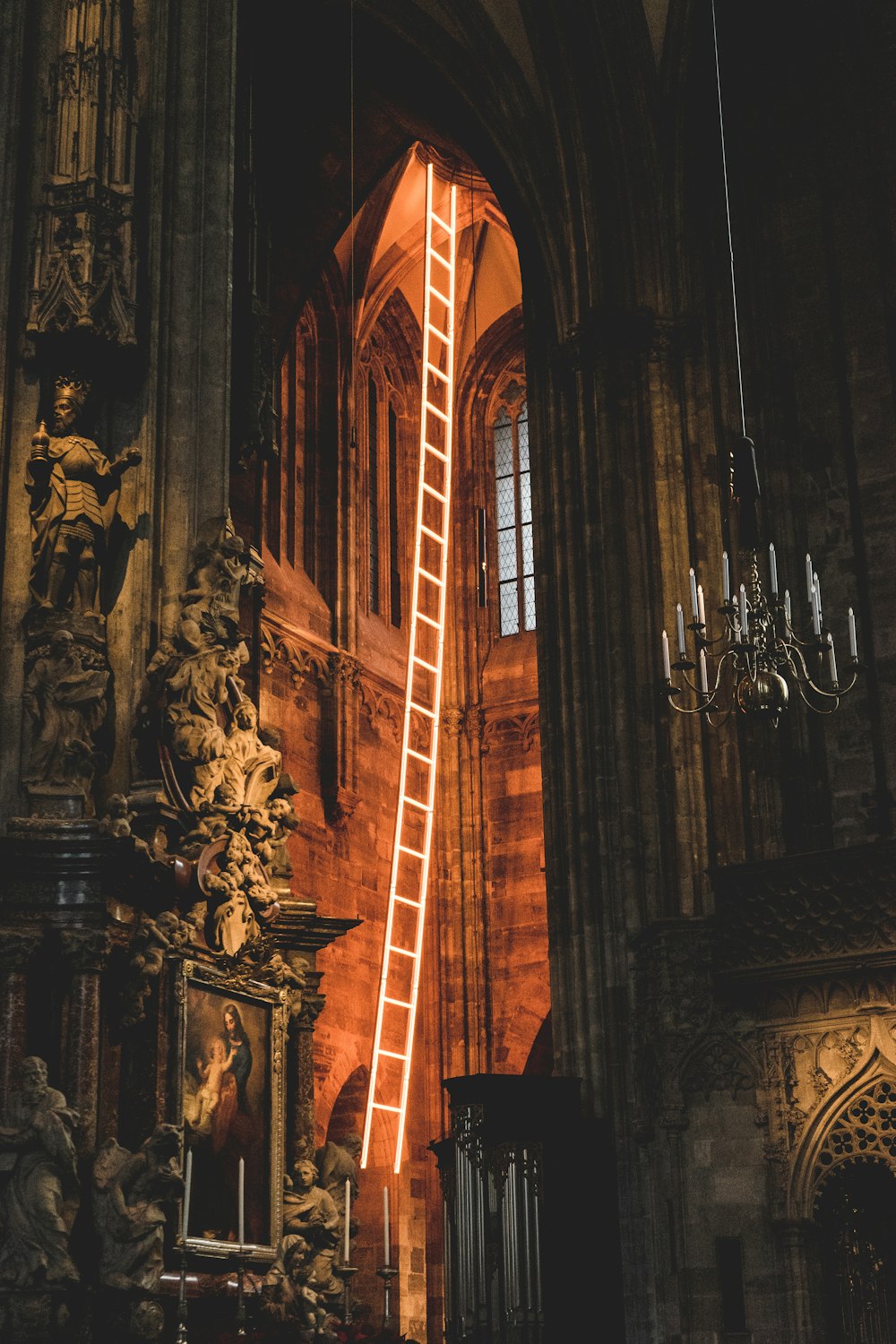 a ladder is lit up in a cathedral