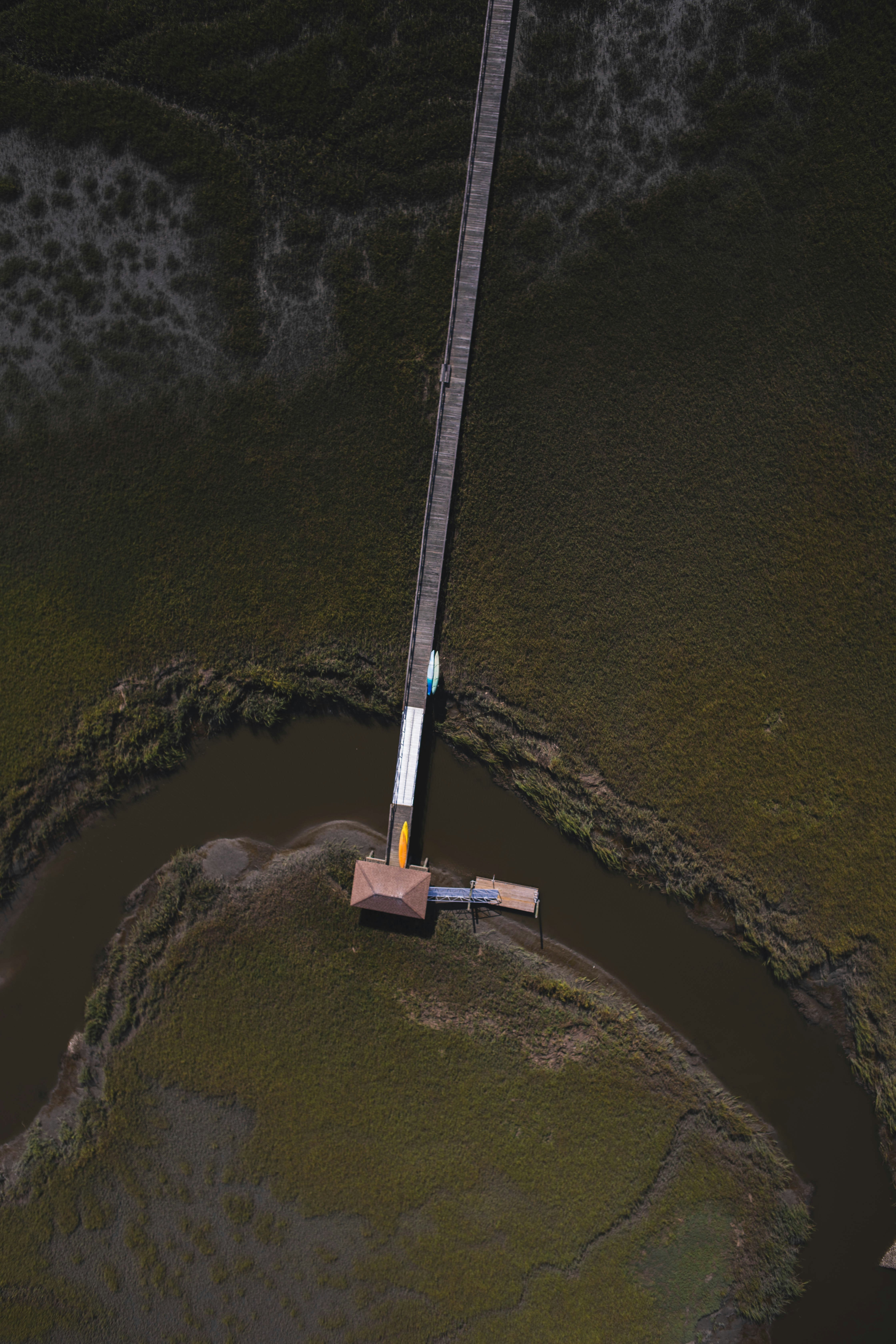 an aerial view of a train crossing a bridge