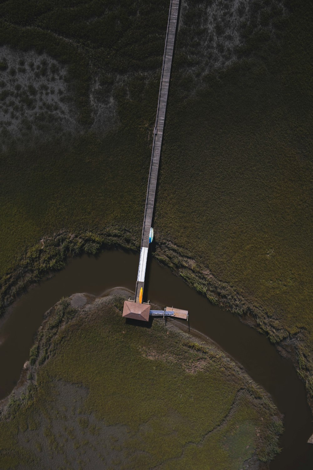 an aerial view of a train crossing a bridge