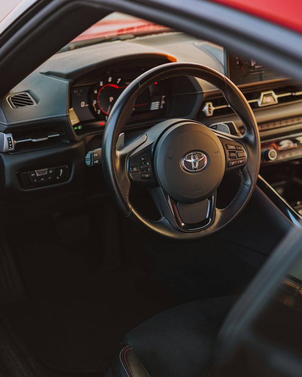 the interior of a car with a steering wheel and dashboard