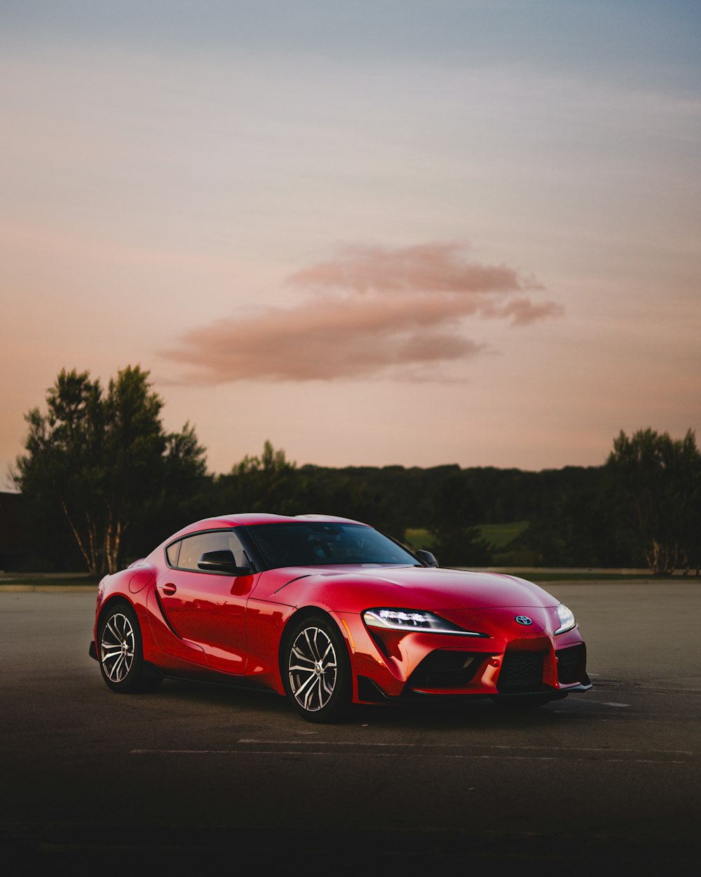 a red sports car parked in a parking lot